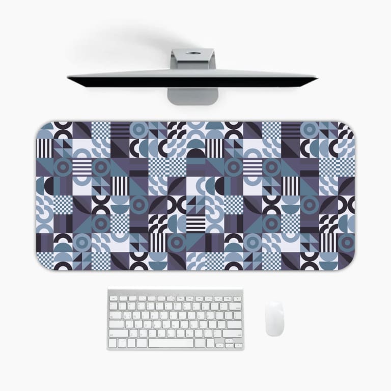 Infidu desk pad with bold geometric shapes in cool tones of blue, black, white, and purple.