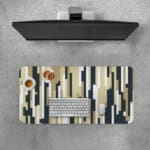 Infidu desk pad with vertical pixel stripe design in beige, black, gray, and white for a modern vintage art-inspired look.