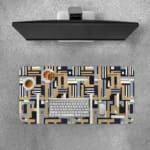 Infidu desk pad with geometric pattern in beige, navy, and gray on a white background