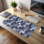 Infidu desk pad with bold geometric shapes in cool tones of blue, black, white, and purple.