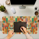 Infidu colorful geometric desk pad with warm red, orange, and yellow tones in a symmetrical pattern.