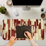 Infidu bold pixel block desk pad with warm red tones and abstract geometric pattern.