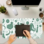 Infidu desk pad with green abstract shapes on white background, inspired by vintage art.