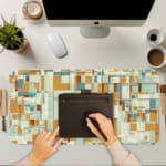 Infidu desk pad with mustard and teal geometric blocks in a modern vintage art style.