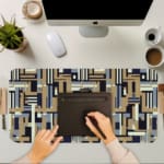 Infidu desk pad with geometric pattern in beige, navy, and gray on a white background