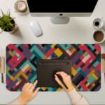 Infidu colorful geometric desk pad with bold blocks in red, teal, mustard, and maroon on a white background.