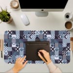 Infidu desk pad with bold geometric shapes in cool tones of blue, black, white, and purple.