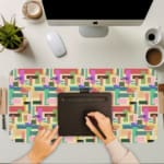 Colorful abstract block pattern desk pad in pastel and bright tones with a playful vintage art design.