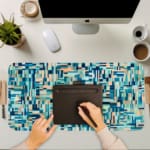 Infidu modern geometric desk pad with cool shades of blue, teal, and beige in a mosaic pattern on a white background.