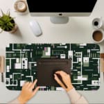 Infidu desk pad with forest green tech-inspired geometric design and vintage art influence