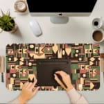 Infidu desk pad with tribal geometric design in earthy tones like maroon, olive green, mustard, and beige on a white background