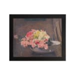 Vintage wall art of pink and yellow flowers in a white bowl with a brown textured background, framed in black. hung on the wall