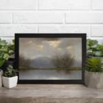 Vintage reflective landscape wall art with soft grays, blues, and greens, showing water reflections, bare trees, and low hills. displayed on the wall