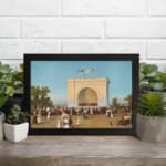 Vintage wall art of a 19th-century crowd in front of a grand white arch with flags, blue sky, and trees, framed in black. displayed on the wall