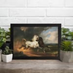 Vintage wall art of a white and dark brown horse in motion under a stormy sky with dramatic clouds and open fields. displayed on the wall