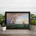 Vintage nautical wall art with two elegant sailboats on a deep green ocean under a dramatic sky. displayed on the wall