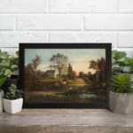 Infidu vintage wall art features a serene countryside scene with a charming house, tall trees, and a soft blue sky. displayed on the wall art in a black frame
