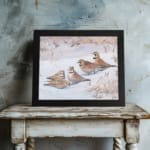Snowy Birds Vintage Wall Art with small birds sitting on a snowy ground in soft winter tones, bringing a peaceful atmosphere. displayed on the wall