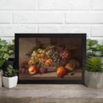 Rustic still-life painting of peaches, grapes, and pears in warm tones with a brown background and black frame. displayed on the wall