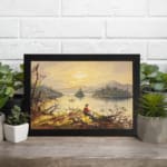 Vintage wall art of a fisherman by a calm lake at sunset with golden sky and soft reflections. displayed on the wall