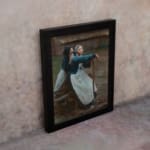 Vintage wall art of two women in traditional clothing by a wooden fence in a rustic countryside setting. displayed on the wall