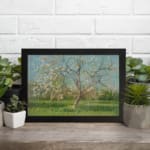 Vintage wall art of a spring meadow with a blossoming tree in soft pink, green, and blue tones by Infidu. displayed on the wall