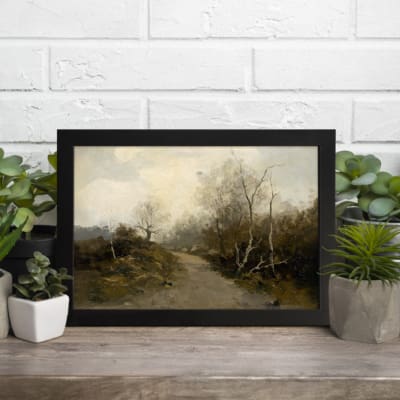 Vintage wall art featuring a serene pathway surrounded by trees and bushes, framed in black with muted earthy tones. displayed on the table in a black frame