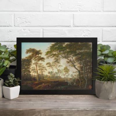 Vintage wall art featuring tall trees and open sky in soft greens, browns, and blues, framed in black for an elegant finish. displayed on the table in a black frame
