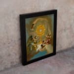 Vintage wall art of angels surrounding a glowing golden sacred symbol with soft clouds and light in the background. displayed on the wall