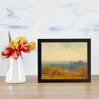 Vintage wall art of an autumn city view with golden trees, a hazy sky, and a soft, distant town skyline. displayed on the wall