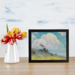 Infidu vintage wall art with blue sky, fluffy white cloud, green hill, and small trees in a peaceful outdoor landscape. displayed on the wall
