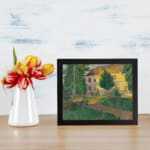 Vintage countryside house with trees and greenery wall art displayed on the wall