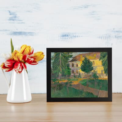 Vintage countryside house with trees and greenery wall art displayed on the wall