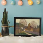 Vintage countryside autumn scene wall art with houses, colorful trees, and soft natural colors in a serene, peaceful setting. displayed on the wall