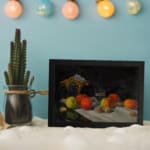 Infidu Classic Still-Life Fruit and Drink Vintage Wall Art with apples, oranges, grapes, and a clear glass on a dark background. displayed on the wall
