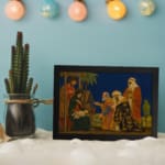 Vintage Nativity wall art showing Three Wise Men visiting baby Jesus under a dark blue sky with warm, rich colors and classic details. displayed on the wall