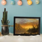 Infidu vintage sunset wall art showcasing calm water, tall trees, and a glowing sky in warm tones of orange, yellow, and brown. displayed on the wall