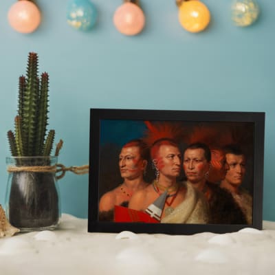 Vintage portrait of five Native American men in traditional attire, highlighting their cultural richness and detailed accessories. displayed on the wall