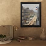 Vintage wall art of a Paris street scene with French flags, horse-drawn carriages, pedestrians, and elegant buildings in soft muted colors. displayed on the wall