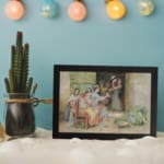 Vintage wall art of women sitting outside a house, talking, with warm tones and traditional details in the background. displayed on the wall