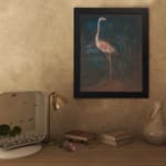 Vintage wall art of a pink flamingo standing in a dark, natural setting with elegant contrast and tropical plants in the background. displayed on the wall