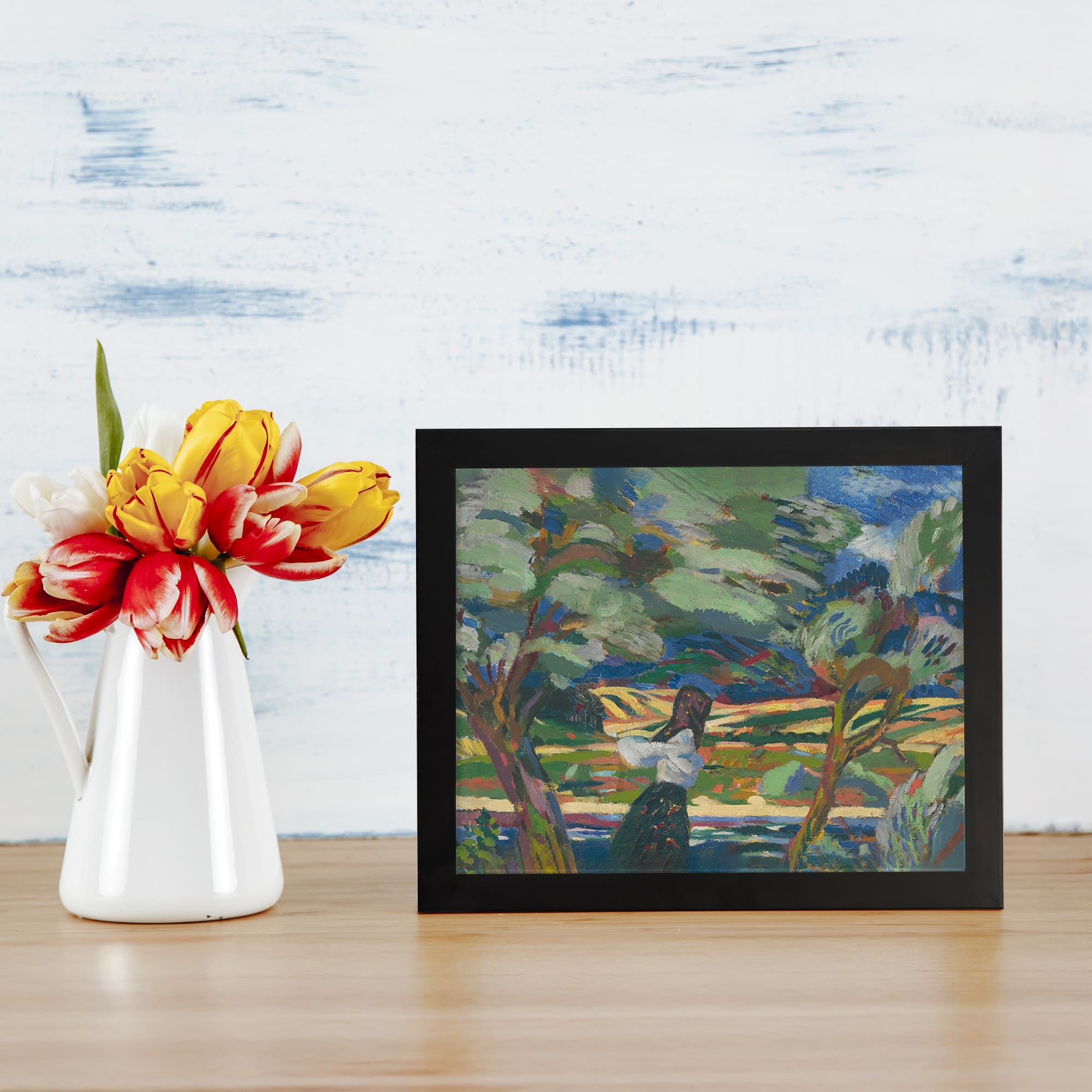 Infidu Vintage Woman Among Trees Colorful Wall Art with vibrant trees, hills, and a dream-like landscape in green, blue, and yellow tones. displayed on the wall