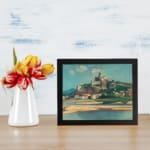Vintage wall art of a hilltop fort and village with scenic river, soft colors, and calm sky. displayed on the wall