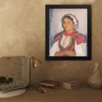 Vintage wall art of Eastern European woman in traditional red and white clothing with embroidered details. displayed on the wall