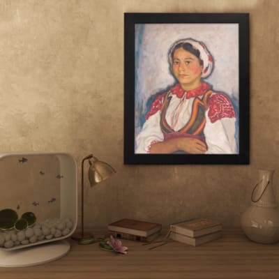 Vintage wall art of Eastern European woman in traditional red and white clothing with embroidered details. displayed on the wall