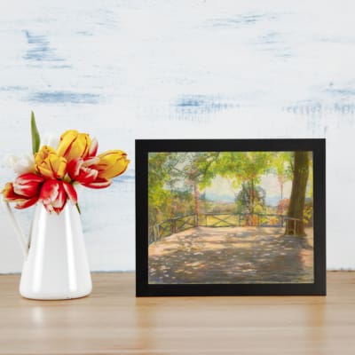 Vintage wall art of a sunny terrace with trees, wooden floor, and distant hills, capturing a peaceful outdoor scene. displayed on the wall