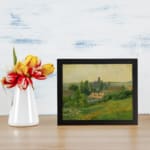 Infidu Vintage Countryside Landscape Wall Art featuring a charming village scene with green fields, trees, and a warm yellow sky. displayed on the wall