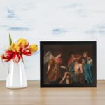 Vintage religious wall art with an angel and three figures in muted robes on a dark background. displayed on the wall