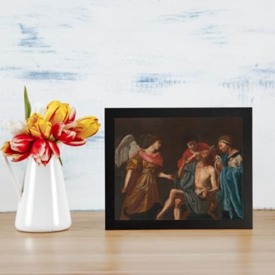 Vintage religious wall art with an angel and three figures in muted robes on a dark background. displayed on the wall
