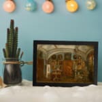 Vintage wall art of an ornate historic interior with chandeliers, framed portraits, and richly detailed furniture in warm earthy tones. displayed on the wall